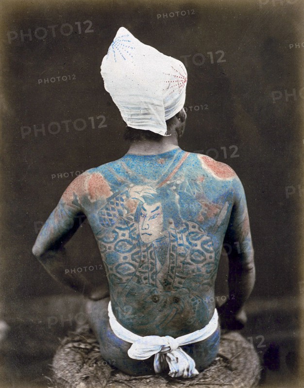 Hand-coloured photograph of a Japanese man with back tattoo Photographed by Felice Beato