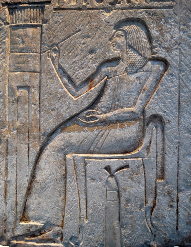 Wall relief fragment with a man decorating his tomb, Limestone. Egyptian.