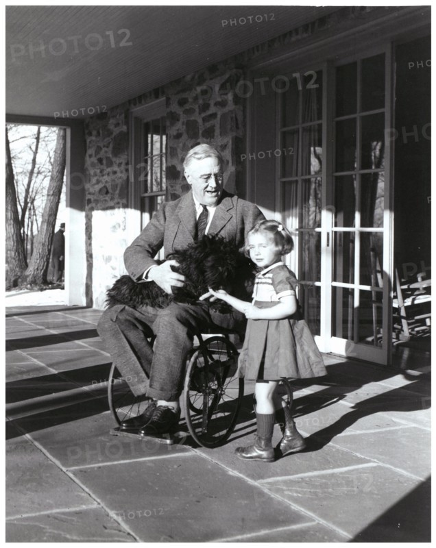 US President Franklin Roosevelt holds his dog