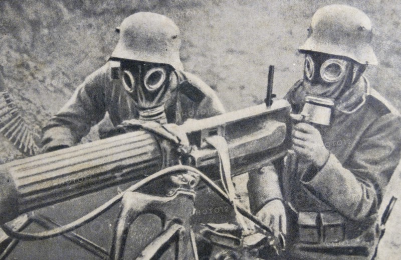 World war one: German soldiers in gas masks use a machine gun