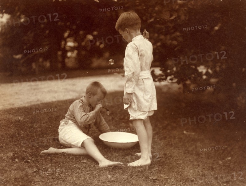 American boys playing in a garden with bubbles