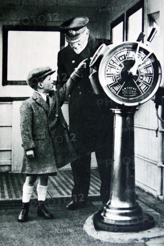 Child visiting the Bridge of an ocean liner with the captain 1936