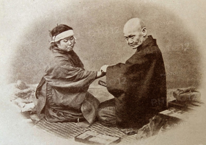 Portrait of a medical man attending to a patient in old Japan