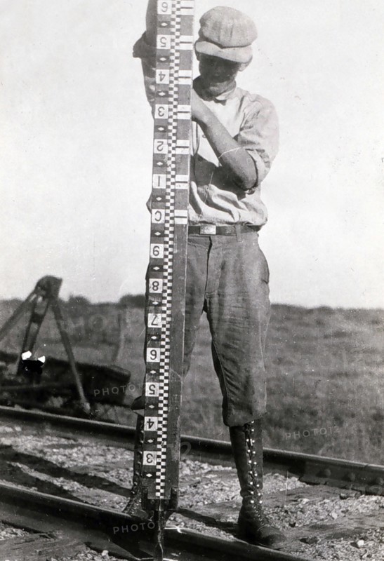 Rodman holding rod vertical during marine oceanographic observations.1900