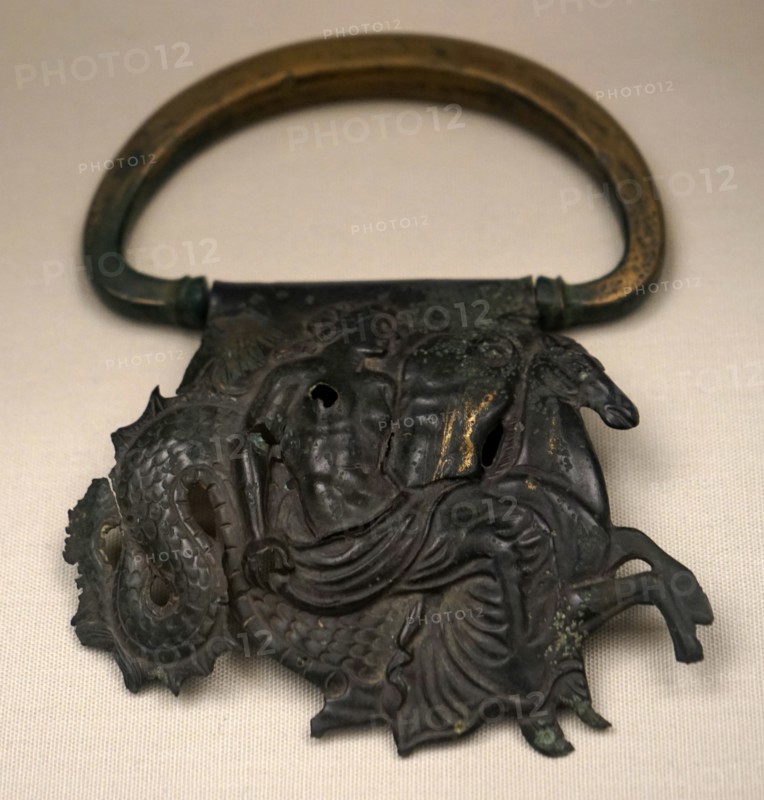 Bronze handle of a vessel decorated with repousse relief