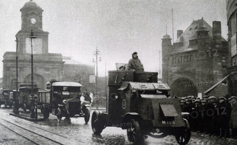 an armoured car escorting a convoy of vehicles in London during the General Strike