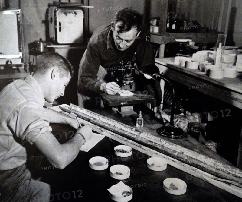 a young boy studying samples from the sea floor