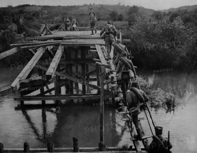 Serbian soldiers cross a temporary bridge at the river koloubara.