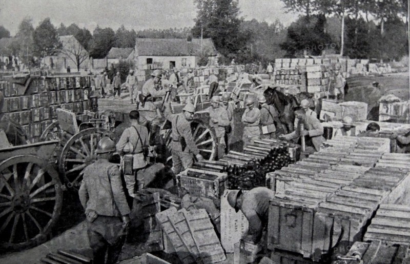 French soldiers load cases of supplies and ammunition.