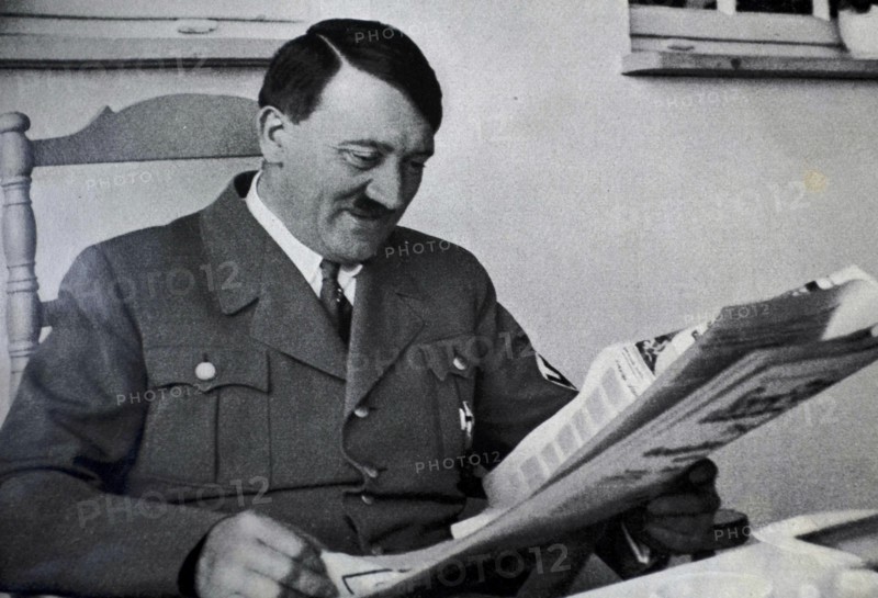 Adolf Hitler reading a newspaper