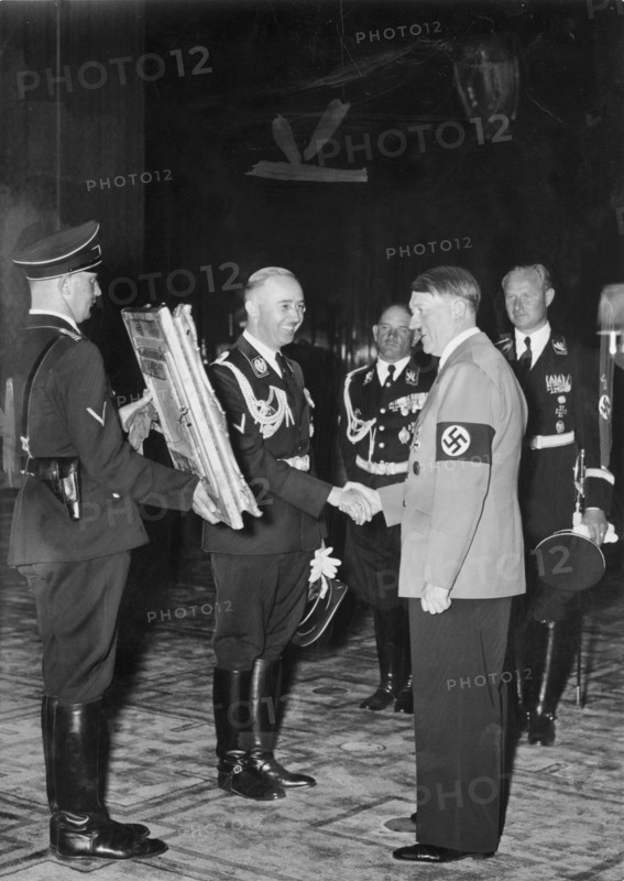 Adolf Hitler presented with a painting from SS Chief Heinrich Himmler, circa 1937.