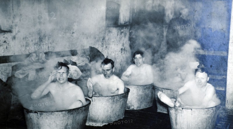 British soldiers from the Dorset shire regiment bath in metal tubs