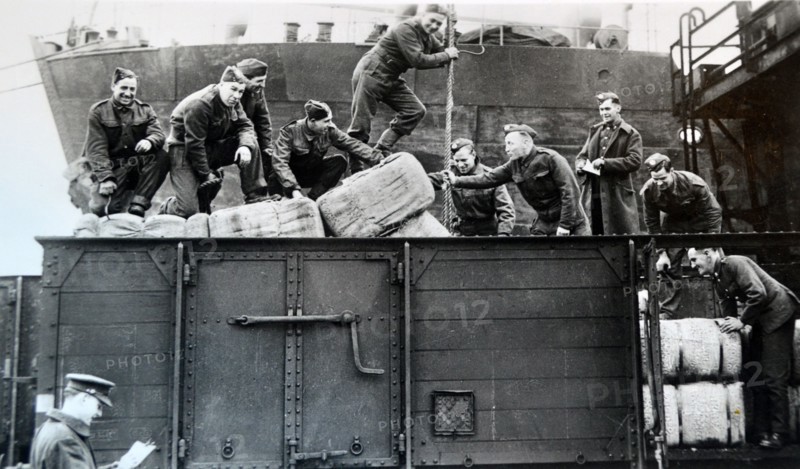 British soldiers load supplies at a railway depot in northern France, 1940