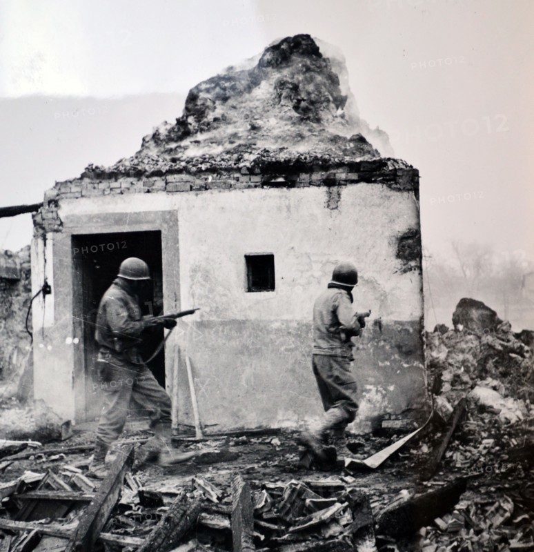 WWII: American soldiers advance building by building through villages