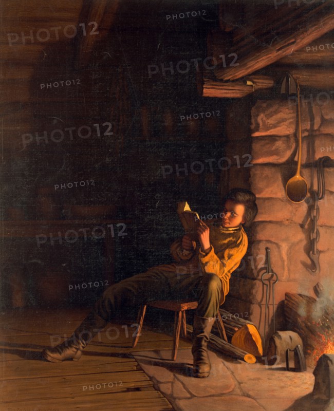 Abraham Lincoln reading by a fireplace