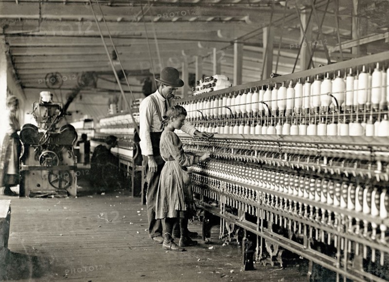 Photograph of Young girl working as a spinner