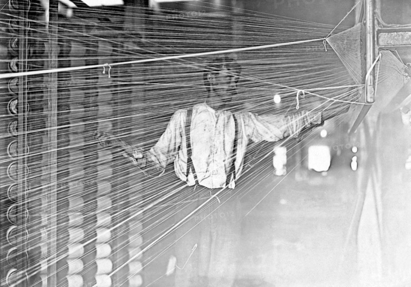 Photograph of a wrapper working at his machine
