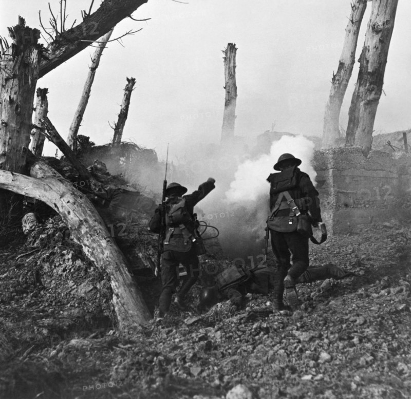 Photograph of American soldiers advancing on a German bunker position