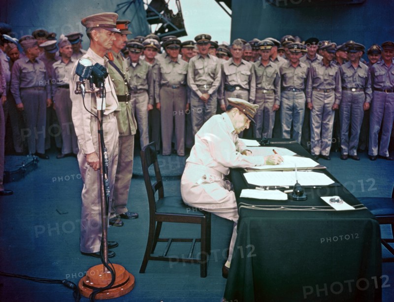 General Douglas MacArthur signing the Instrument of Surrender on behalf of the Allied Powers 1945