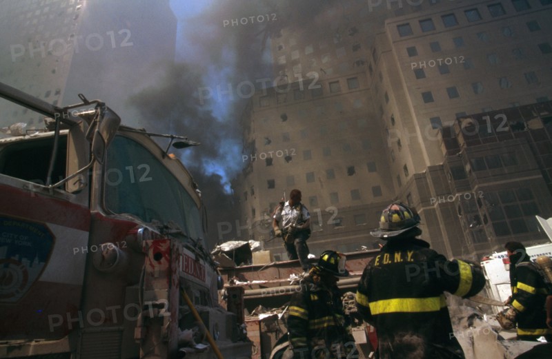 Colour photograph of a New York Fire-fighter amid the rubble of the World Trade Centre following the 9/11 attacks