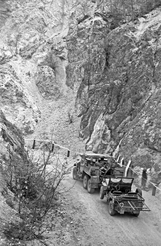 Photograph of a US Army Truck towing a Jeep during World War Two