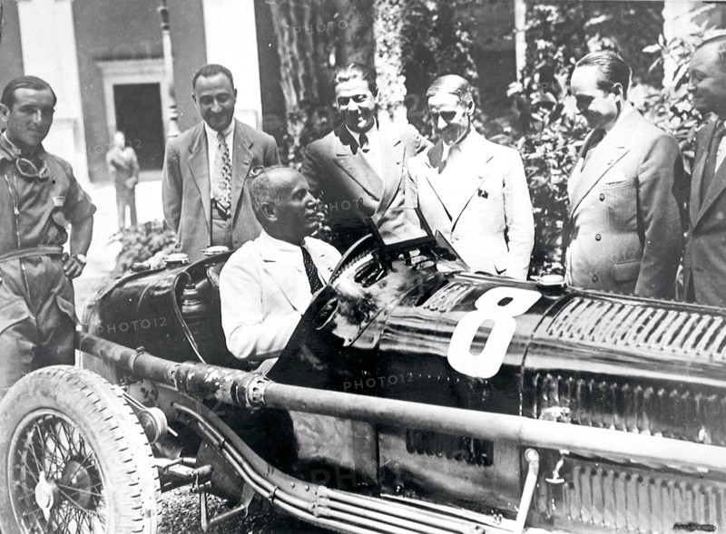 Mussolini sits in an Alfa Romeo racing car, 1934