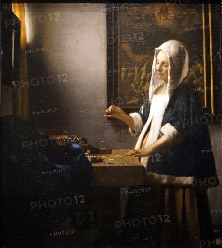 Painting titled 'Woman Holding a Balance' by Johannes Vermeer