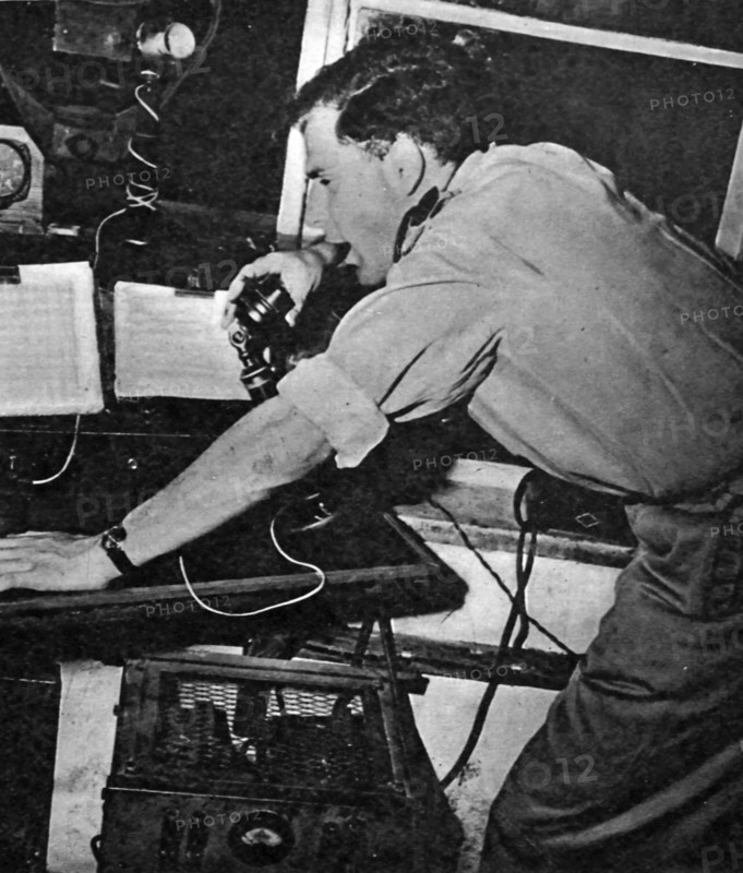 Photograph of a technician aiding aircrafts over the radio at Lydda Airport