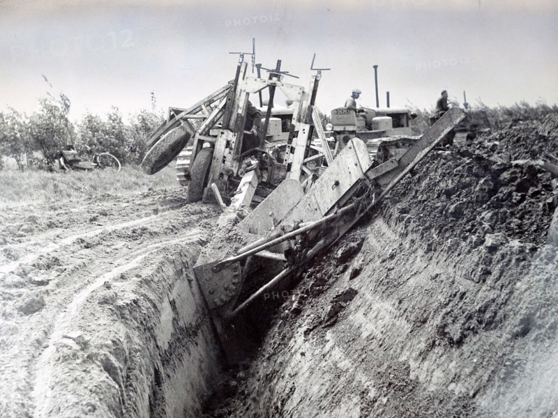 Photograph of a Dutch farmer construction a polder from land reclaimed for the sea bed