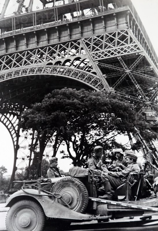 World War Two: German soldiers sit in a vehicle under the Eiffel Tower as they occupy Paris, during the invasion of France 1940
