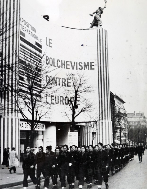 Photograph taken of a Pro-German march, past the Paris exhibition 'Bolshevlsme contra l'europe', during the German occupation of France, in World War Two
