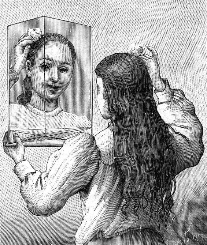 A young girl looking at herself in a mirror
