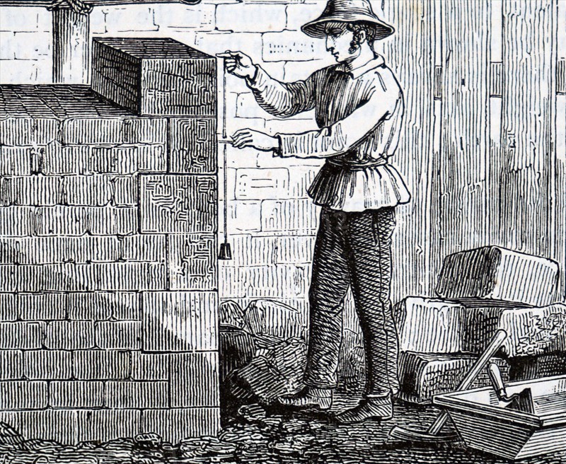 A builder using a plumb line to keep a walk vertical