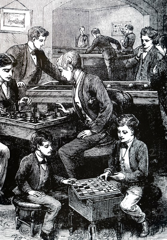 Boys in a games room amusing themselves with, among other things, chess and draughts