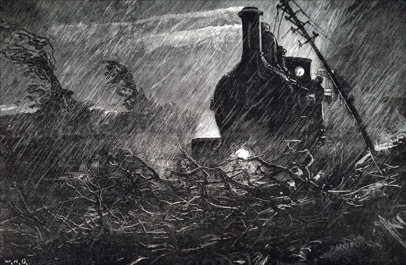 A train halted by debris on the track during a rain storm