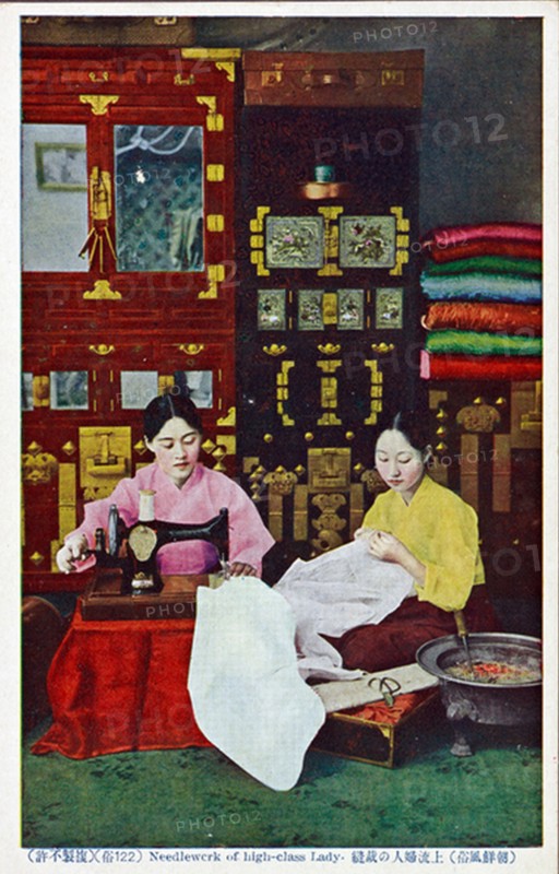 Korean seamstress making clothes for sale in her shop
