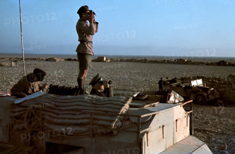 Field Marshal Erwin Rommel watching battlefield 1941 Tunisia in Captured British armoured truck MAX. MAMMUT