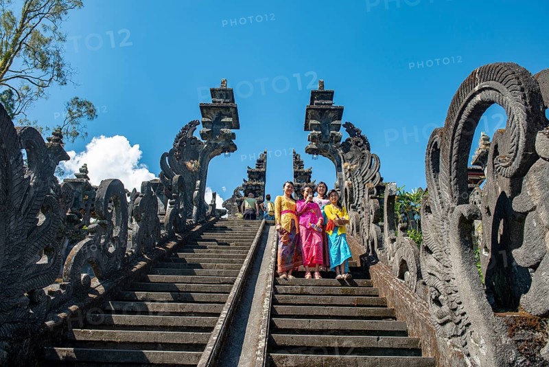Young Balinese women descend stairs