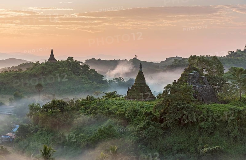 Mist over hills and stupas of Mrauk U at sunrise