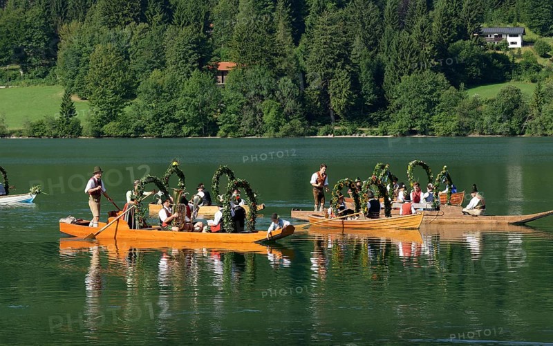 Men wearing traditional costumes in festively decorated squares