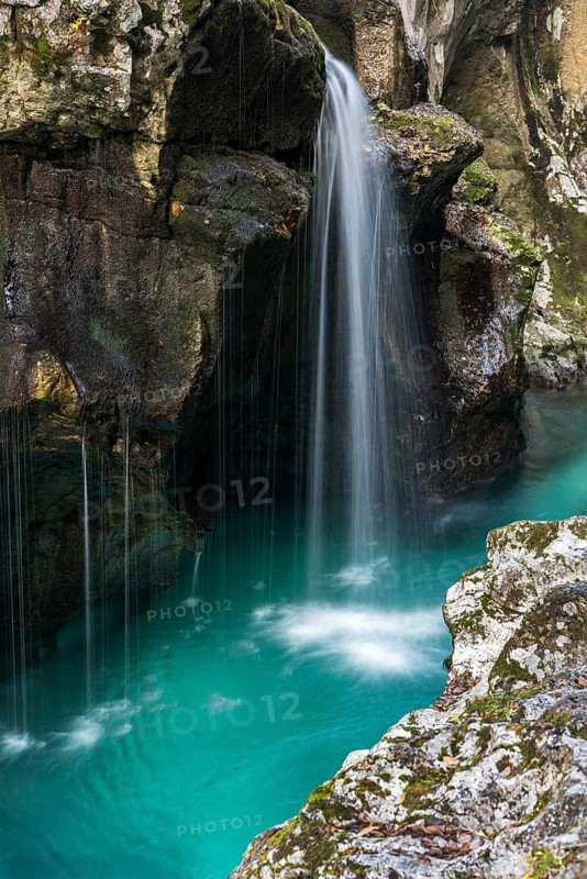 Emerald green wild river Soca flows through rocky gorge