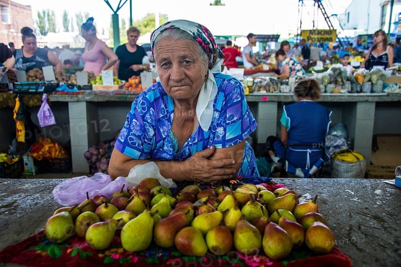 Woman selling apples on a local market