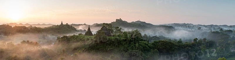 Mist over hills and stupas of Mrauk U at sunrise