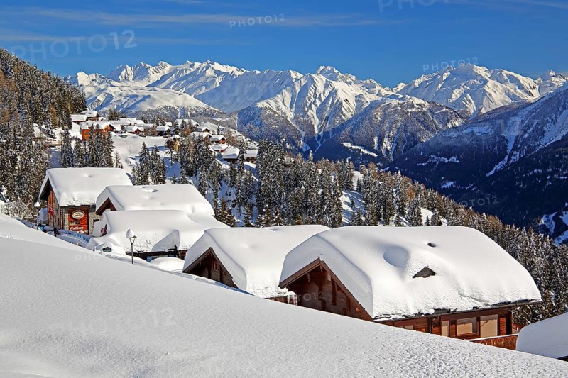 Winter landscape with snow-covered chalets