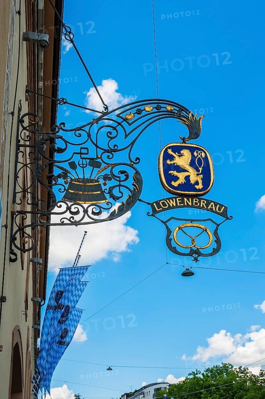 Wrought iron shop sign and flags