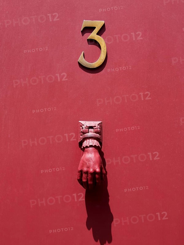 Doorknocker on a red door