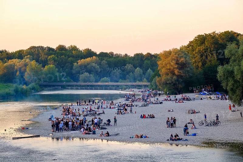 Young people on gravel bank at the riverbank