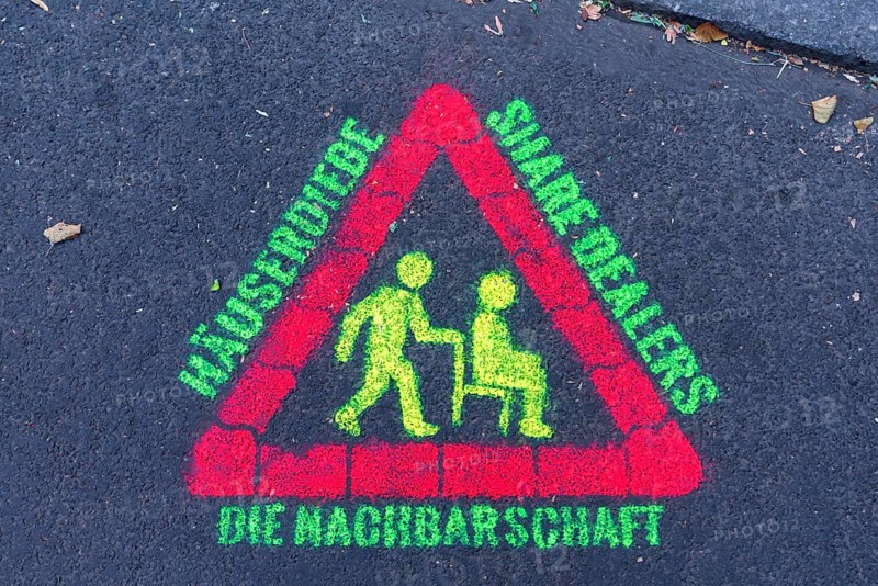 Warning sign against thieves and drugs sprayed with phosphorus paint on street asphalt