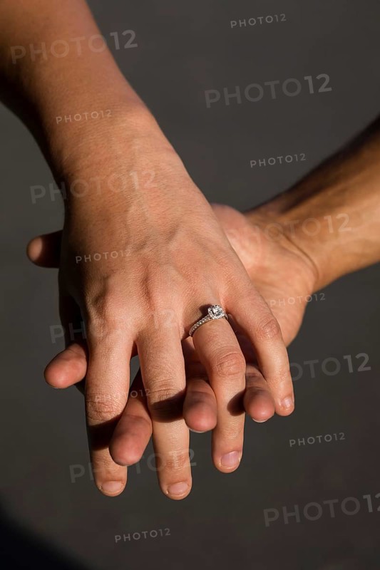 Engaged couple holding hands