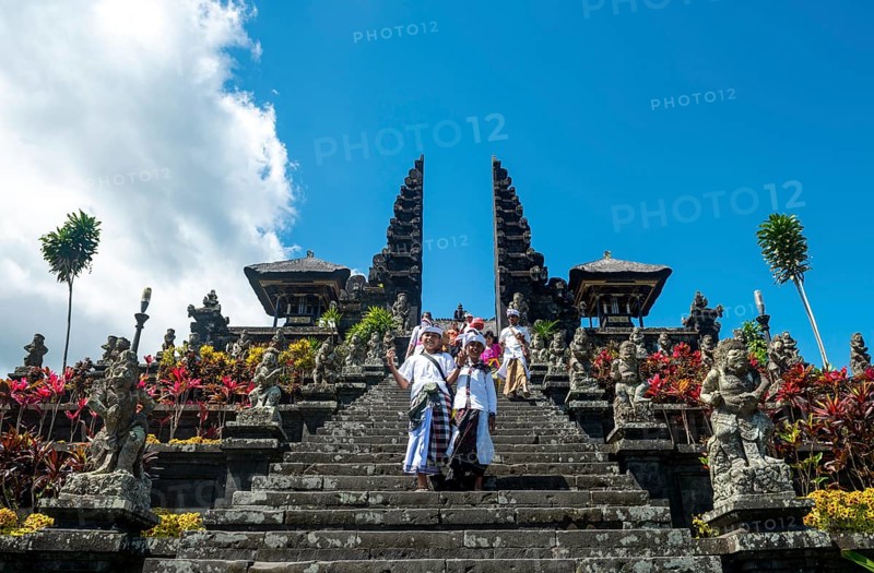 Two Balinese boys go down stairs
